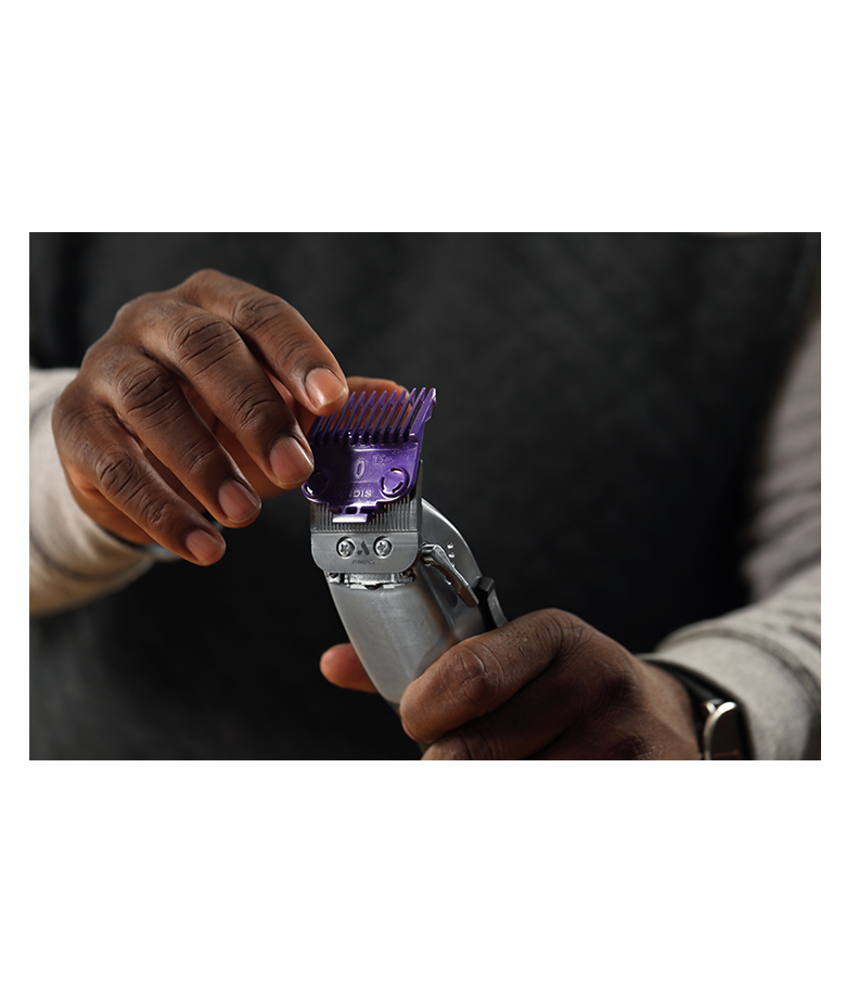 man holding master cordless clipper attaching purple comb attachment